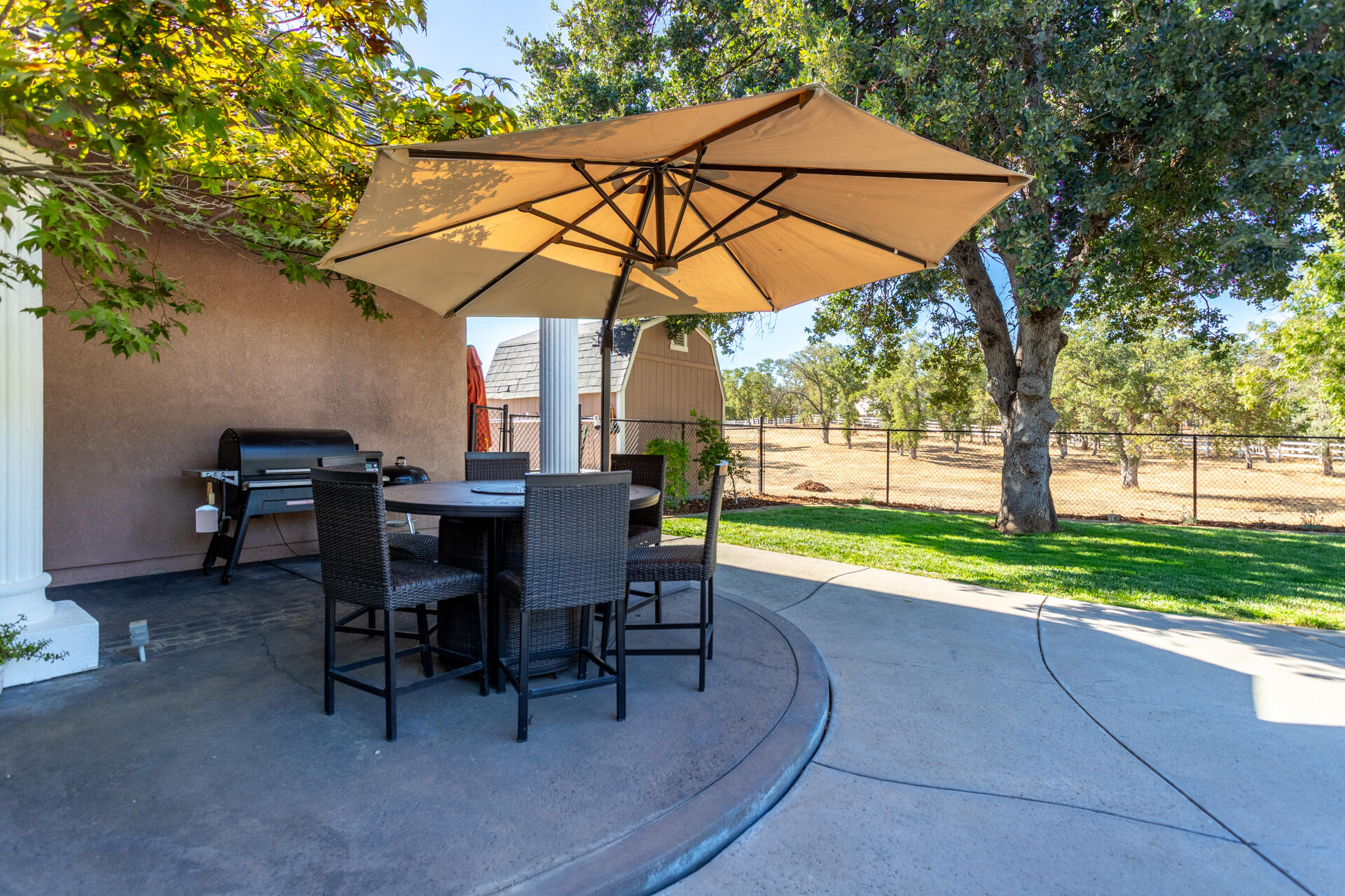 7307 Del Rico Court Palo Cedro, CA 96073 - Photo 35 of 55 a view of a swimming pool with a table and chairs under an umbrella