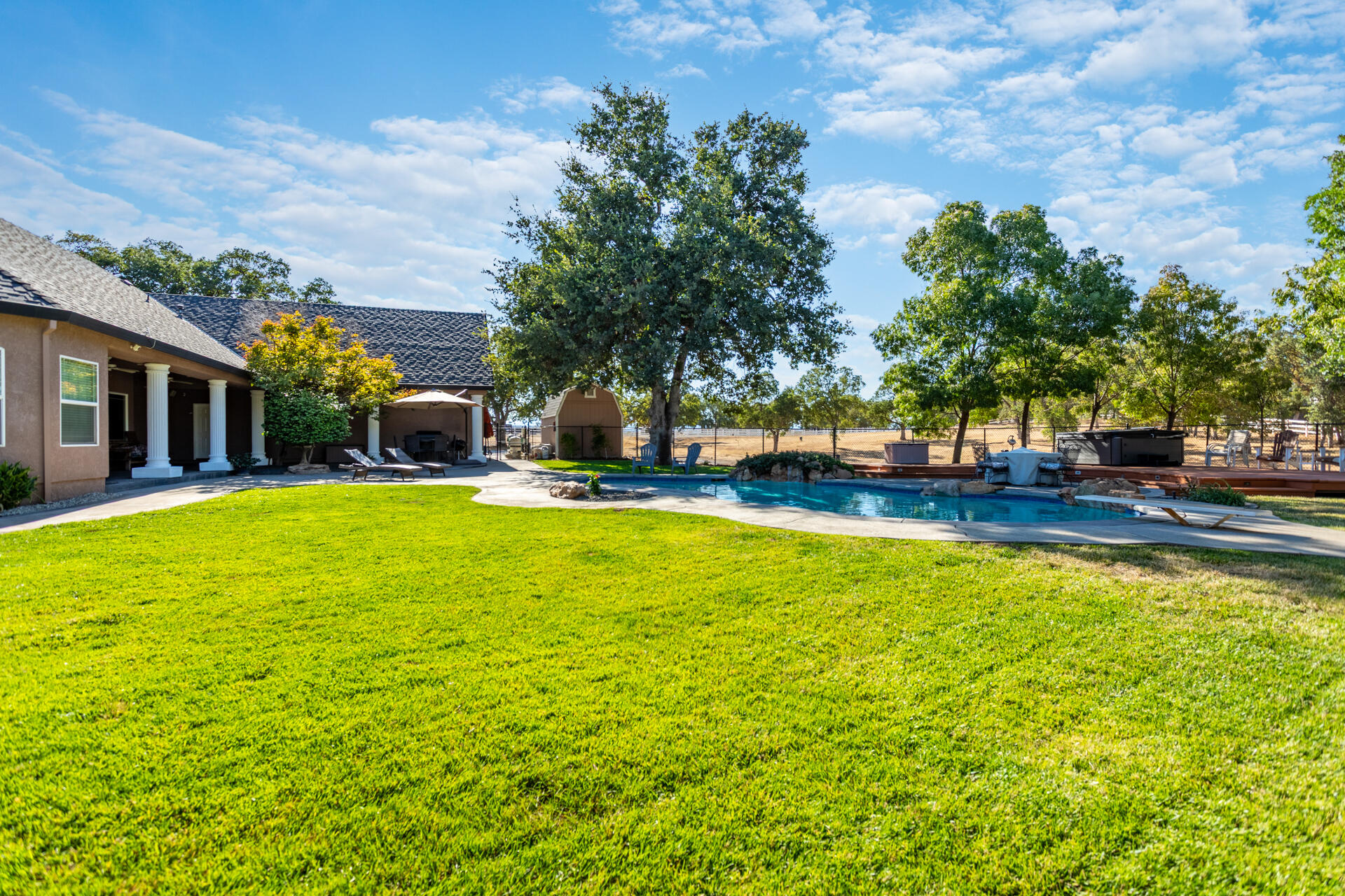 7307 Del Rico Court Palo Cedro, CA 96073 - Photo 39 of 55 a view of a swimming pool with lawn chairs and plants