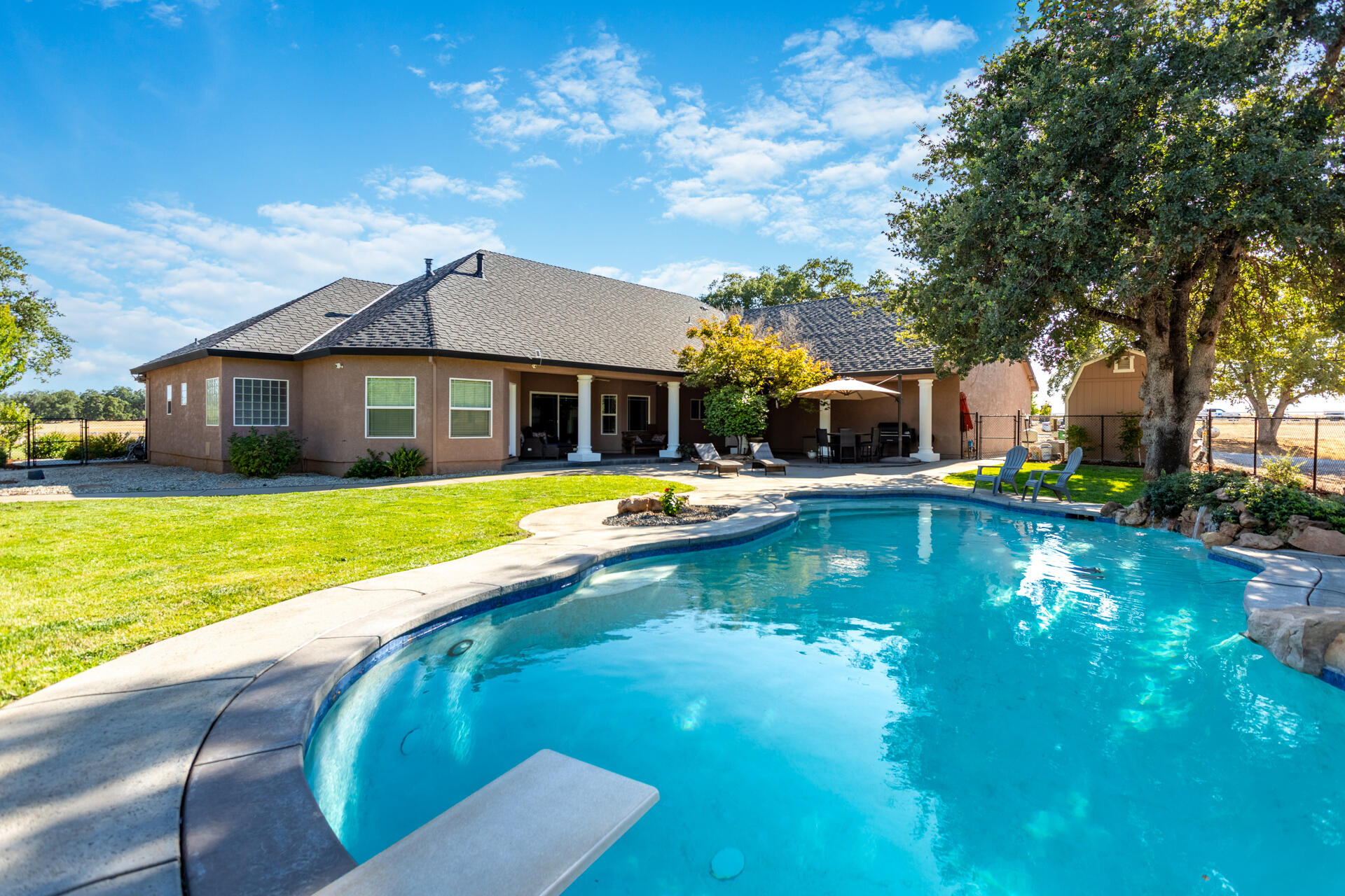 7307 Del Rico Court Palo Cedro, CA 96073 - Photo 43 of 55 a view of a house with swimming pool and porch with furniture