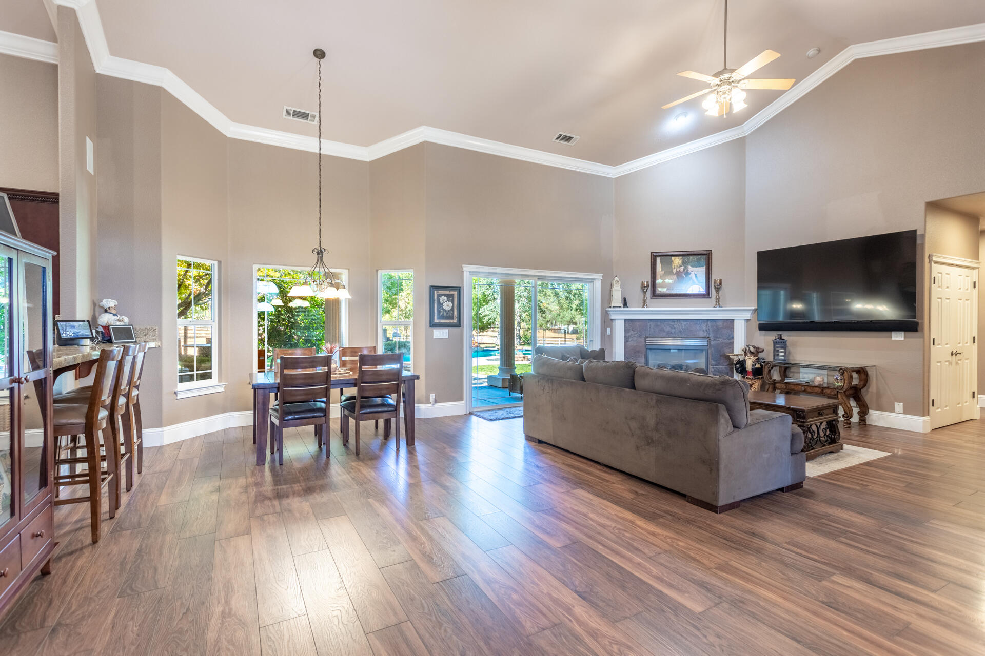 7307 Del Rico Court Palo Cedro, CA 96073 - Photo 8 of 55 a living room with furniture dining table and a flat screen tv