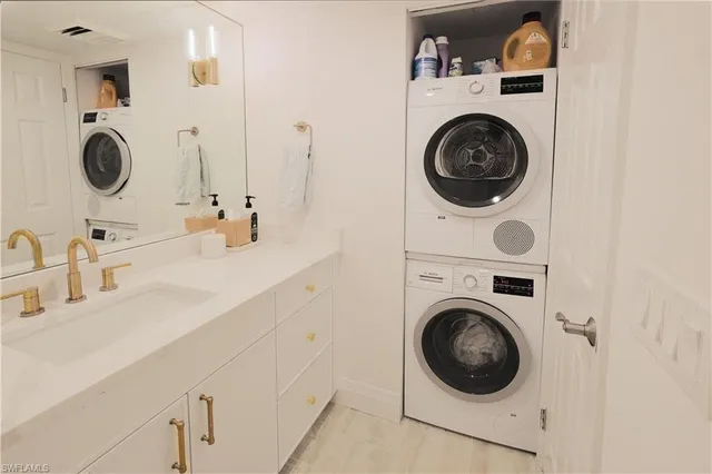 a bathroom with a sink mirror and washer