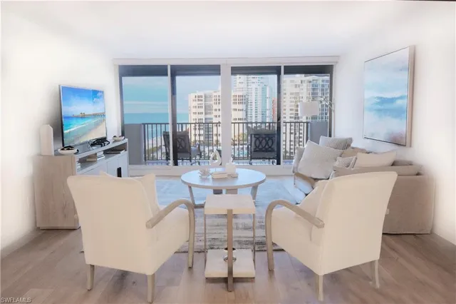 a living room with couches a coffee table and a flat screen tv