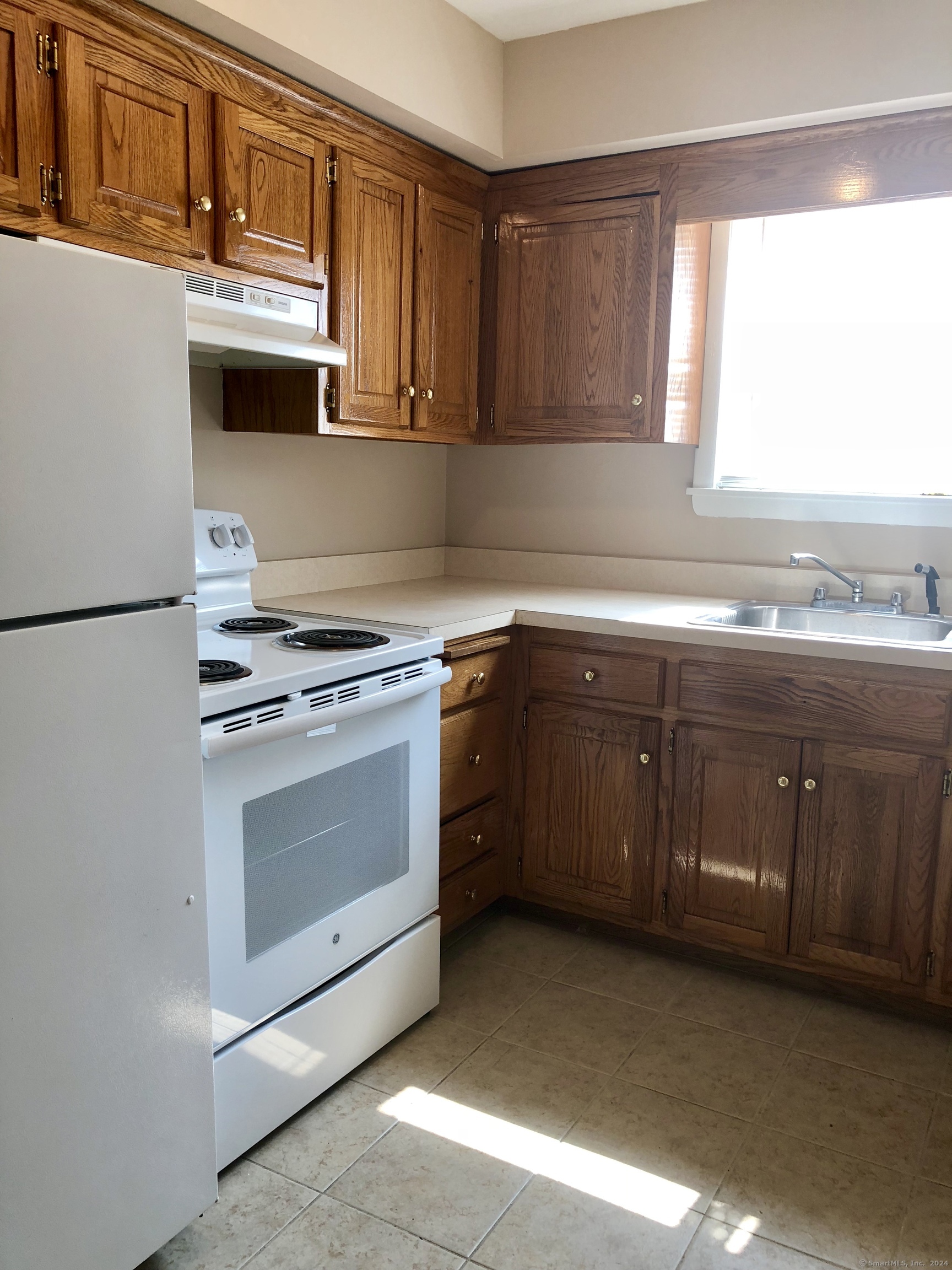 a kitchen with sink a microwave and cabinets