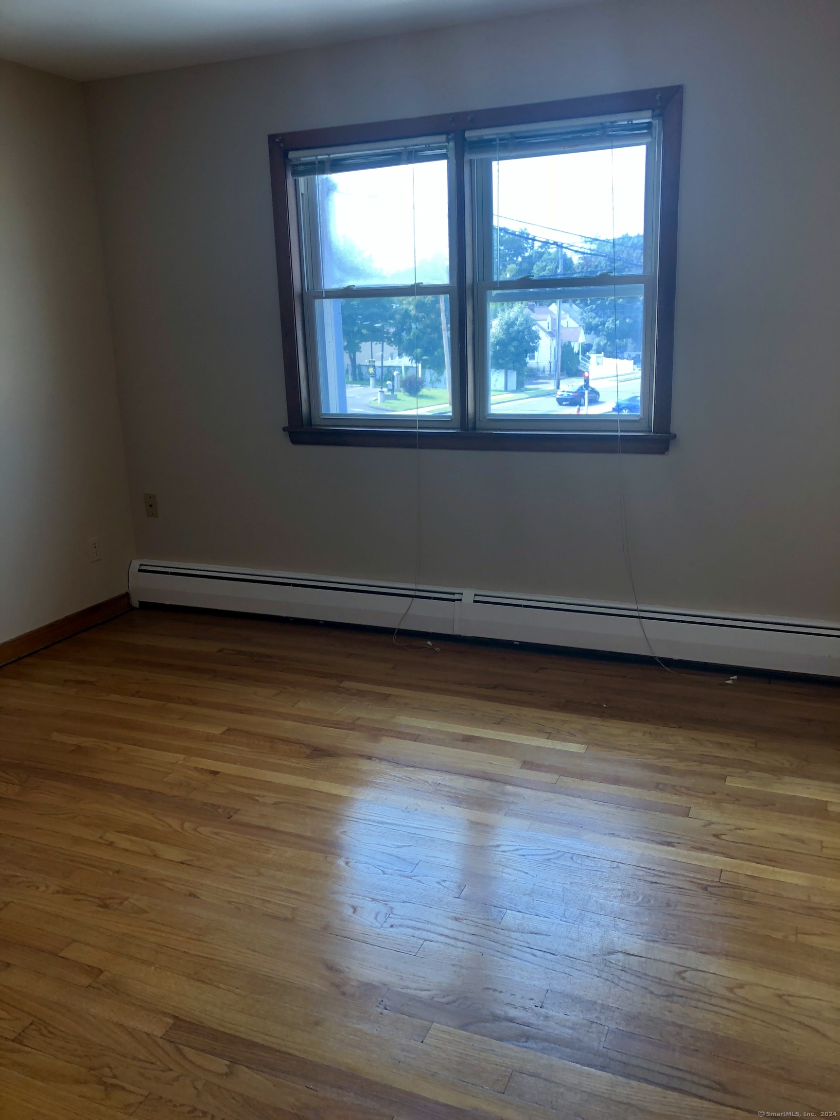 910 Boston Post Road, Unit 3 West Haven, CT 06516 - Photo 2 of 7 a view of a room with wooden floor and a window