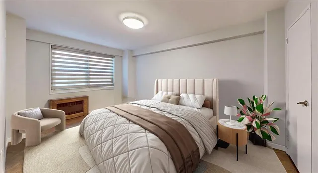 a bedroom with a bed and potted plant