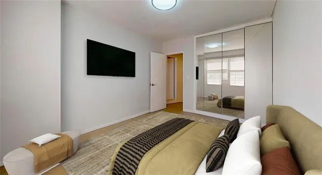 a bedroom with a bed and a flat screen tv