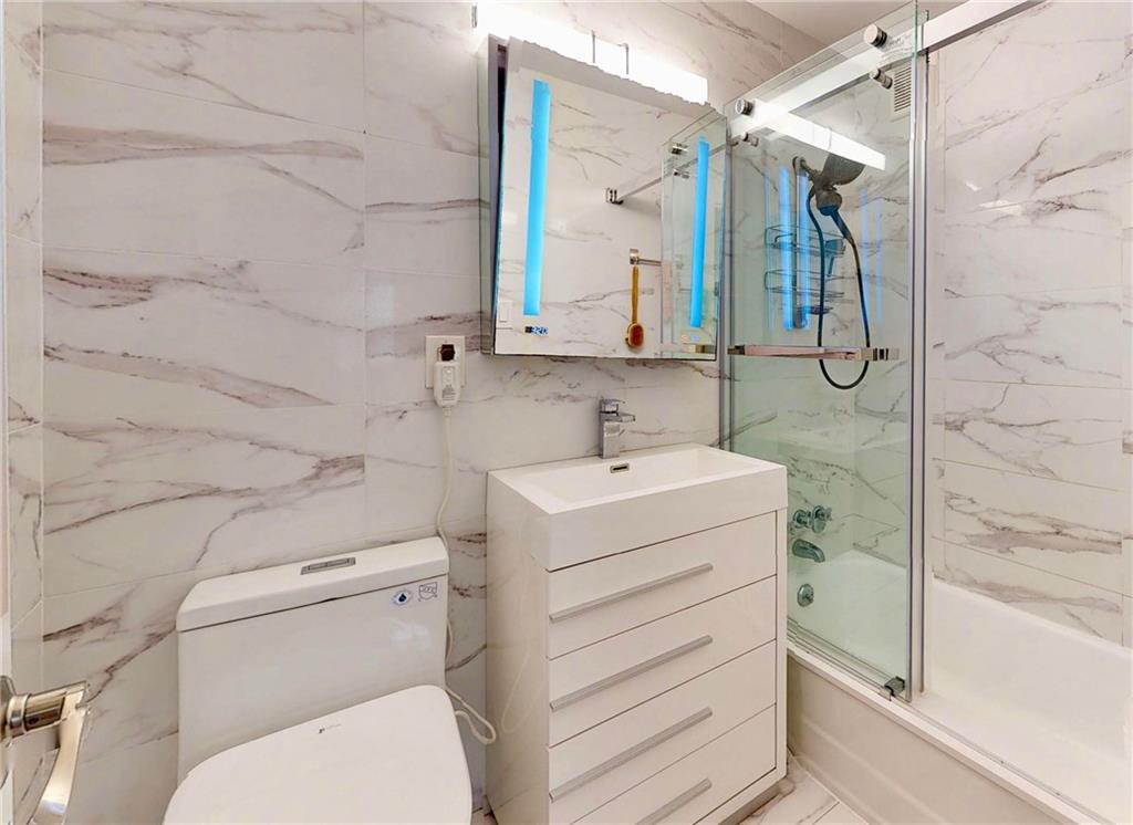 2829 West 5th Street, Unit 3J Brooklyn, NY 11224 - Photo 8 of 11 a bathroom with a sink a toilet and shower