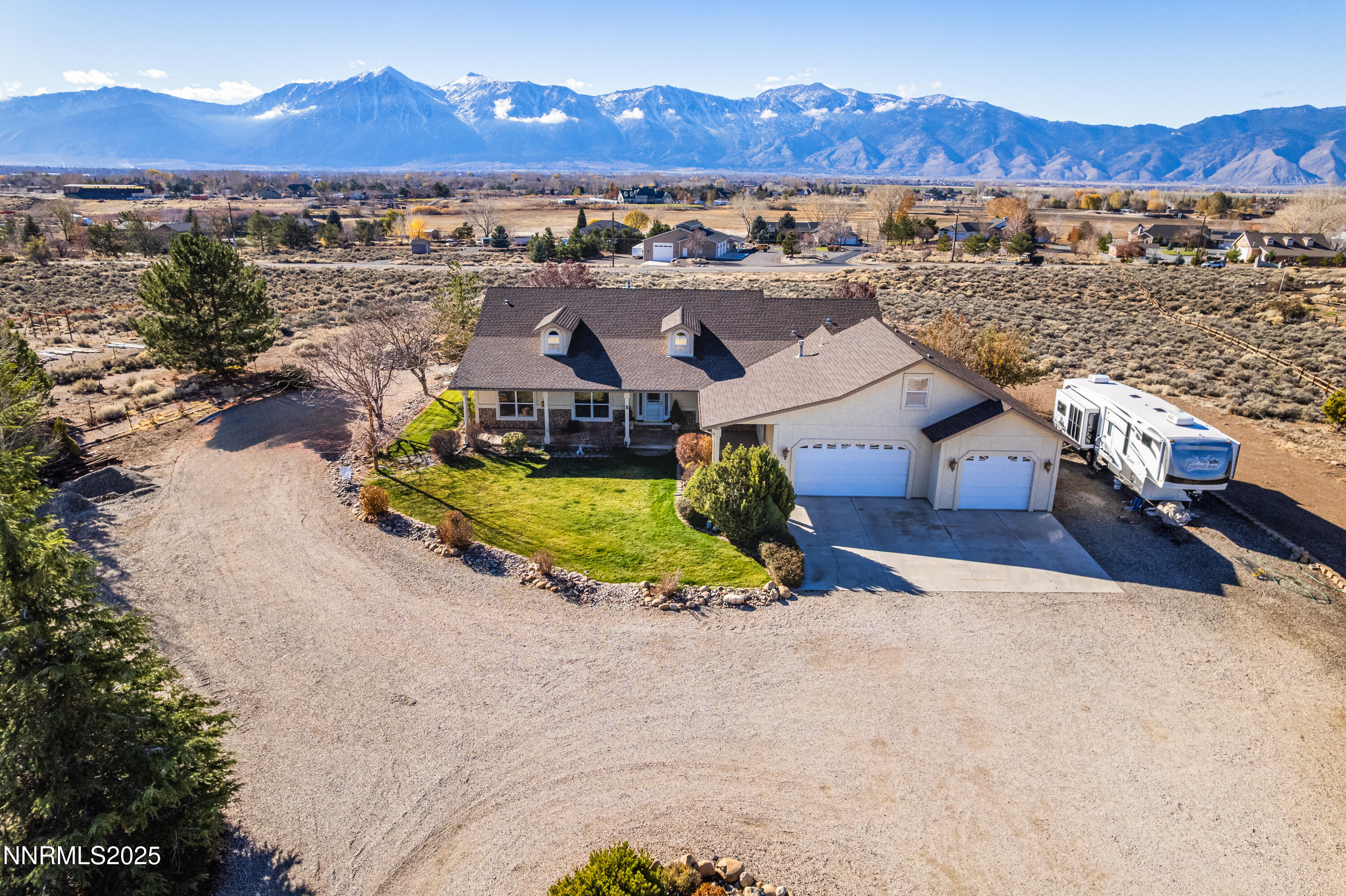 an aerial view of a house with a mountain view