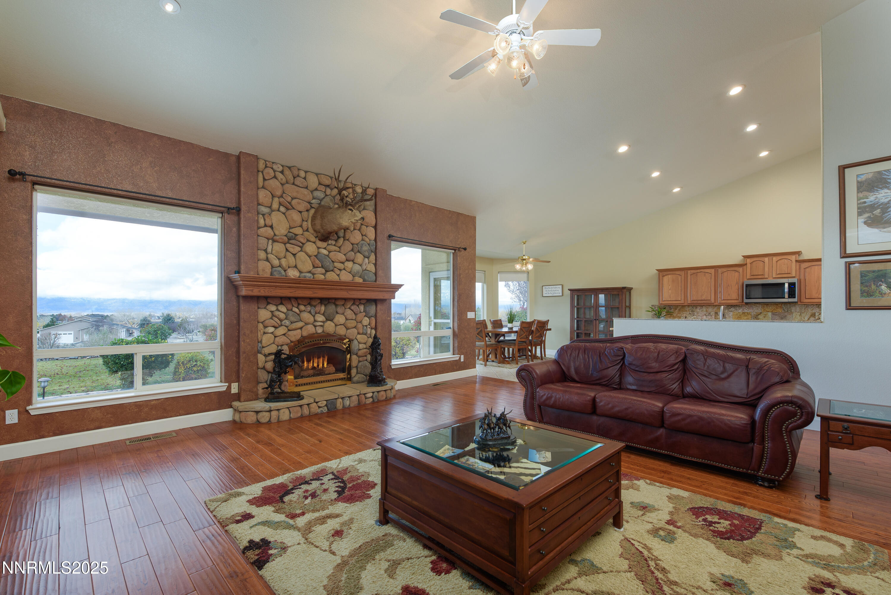 1572 Sawmill Road Gardnerville, NV 89410 - Photo 11 of 43 a living room with furniture a fireplace and a floor to ceiling window