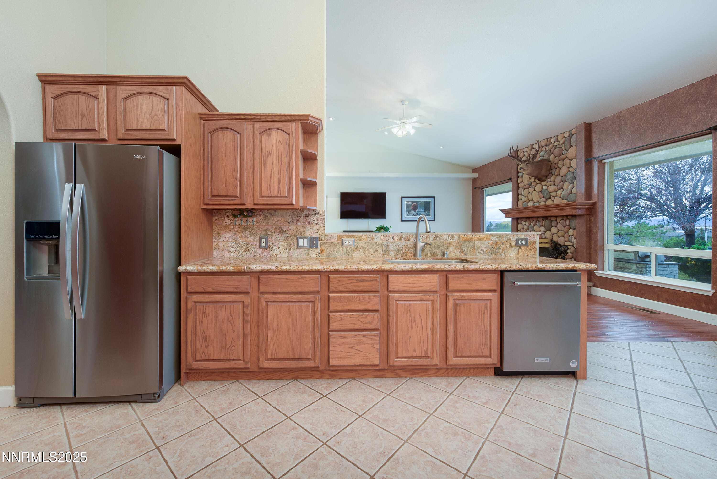 1572 Sawmill Road Gardnerville, NV 89410 - Photo 16 of 43 a kitchen with granite countertop a refrigerator and a sink