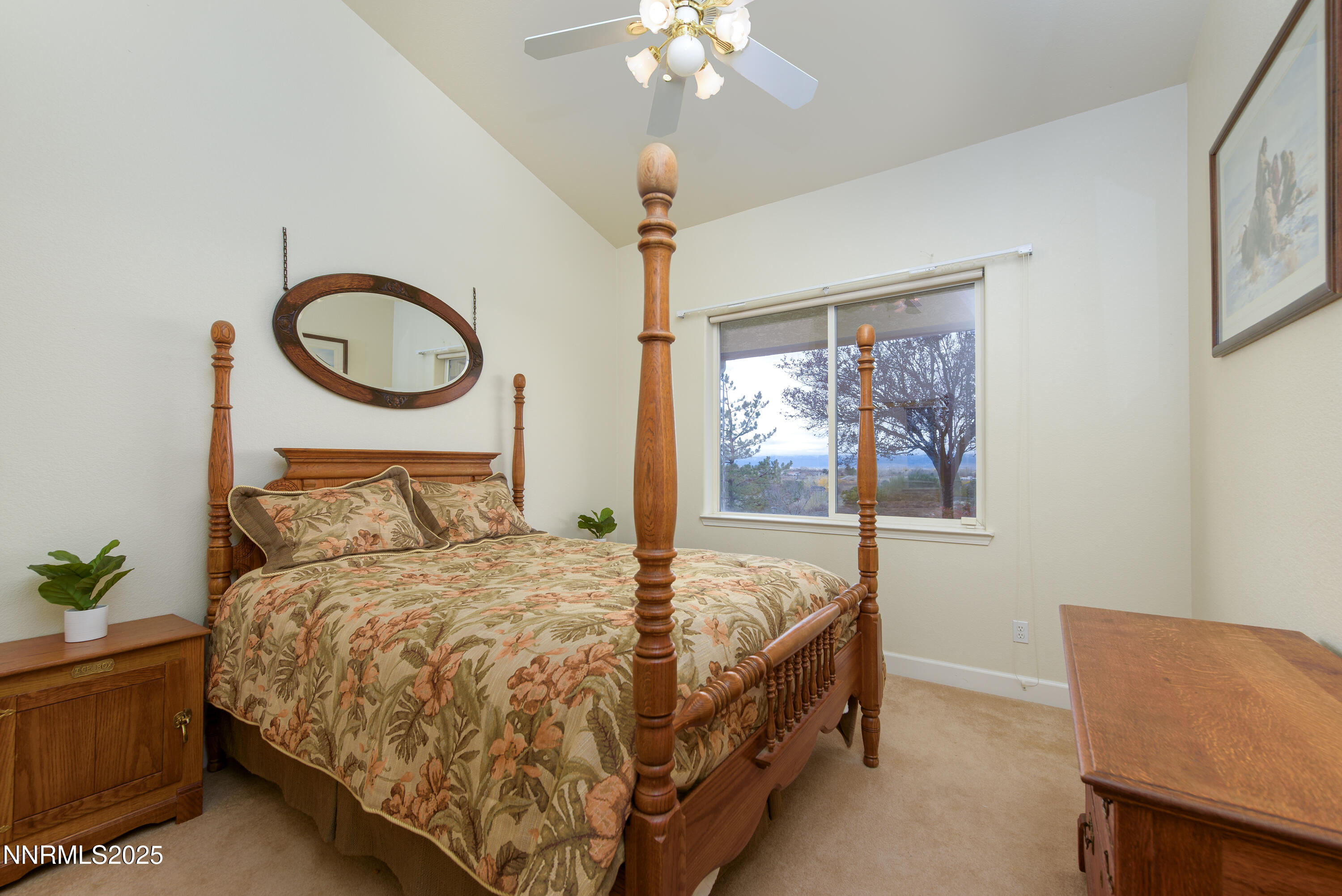 1572 Sawmill Road Gardnerville, NV 89410 - Photo 28 of 43 a bedroom with a bed a chandelier and a window