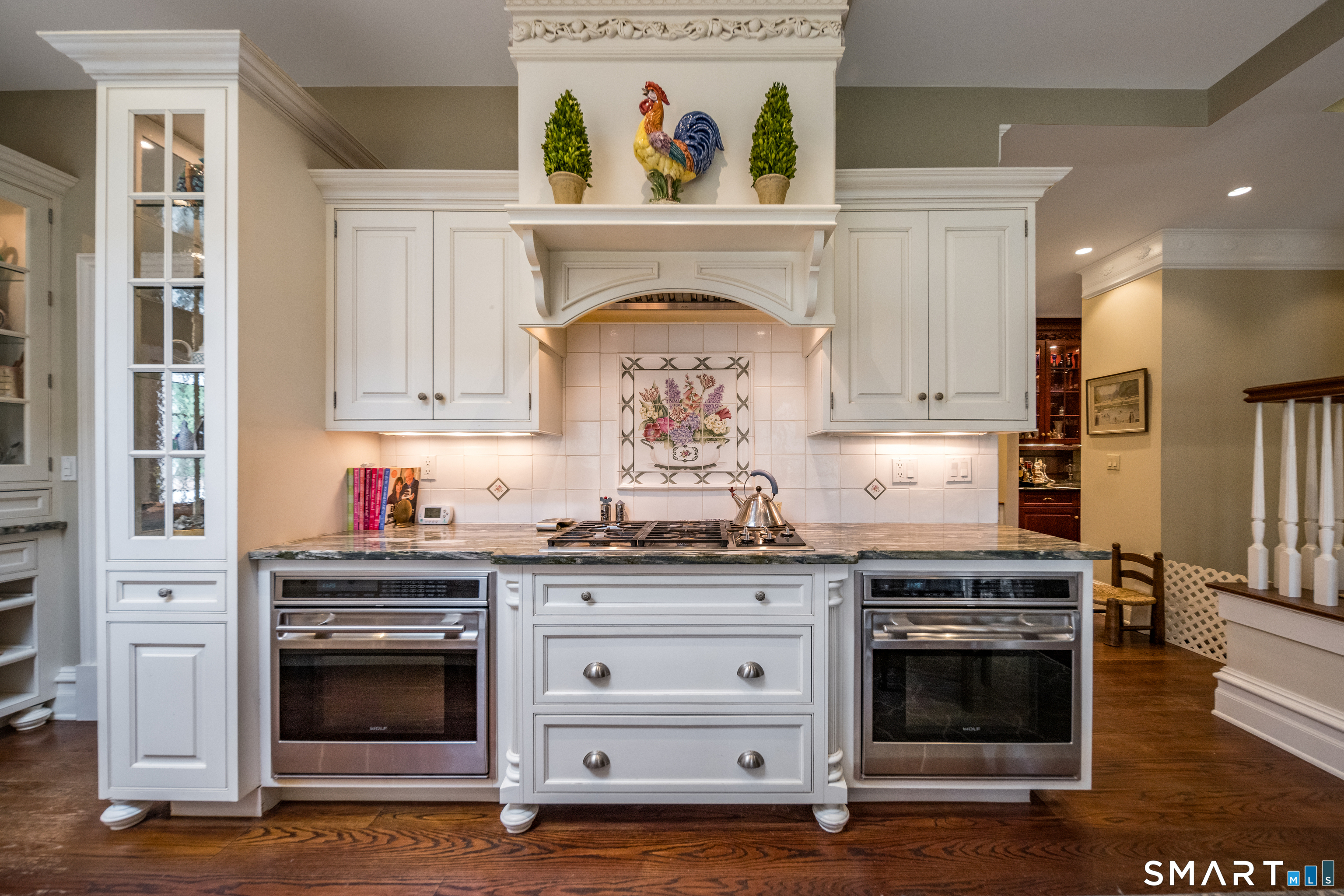 24 Indigo Trail Madison, CT 06443 - Photo 11 of 40 a kitchen with granite countertop a stove and a wooden floor