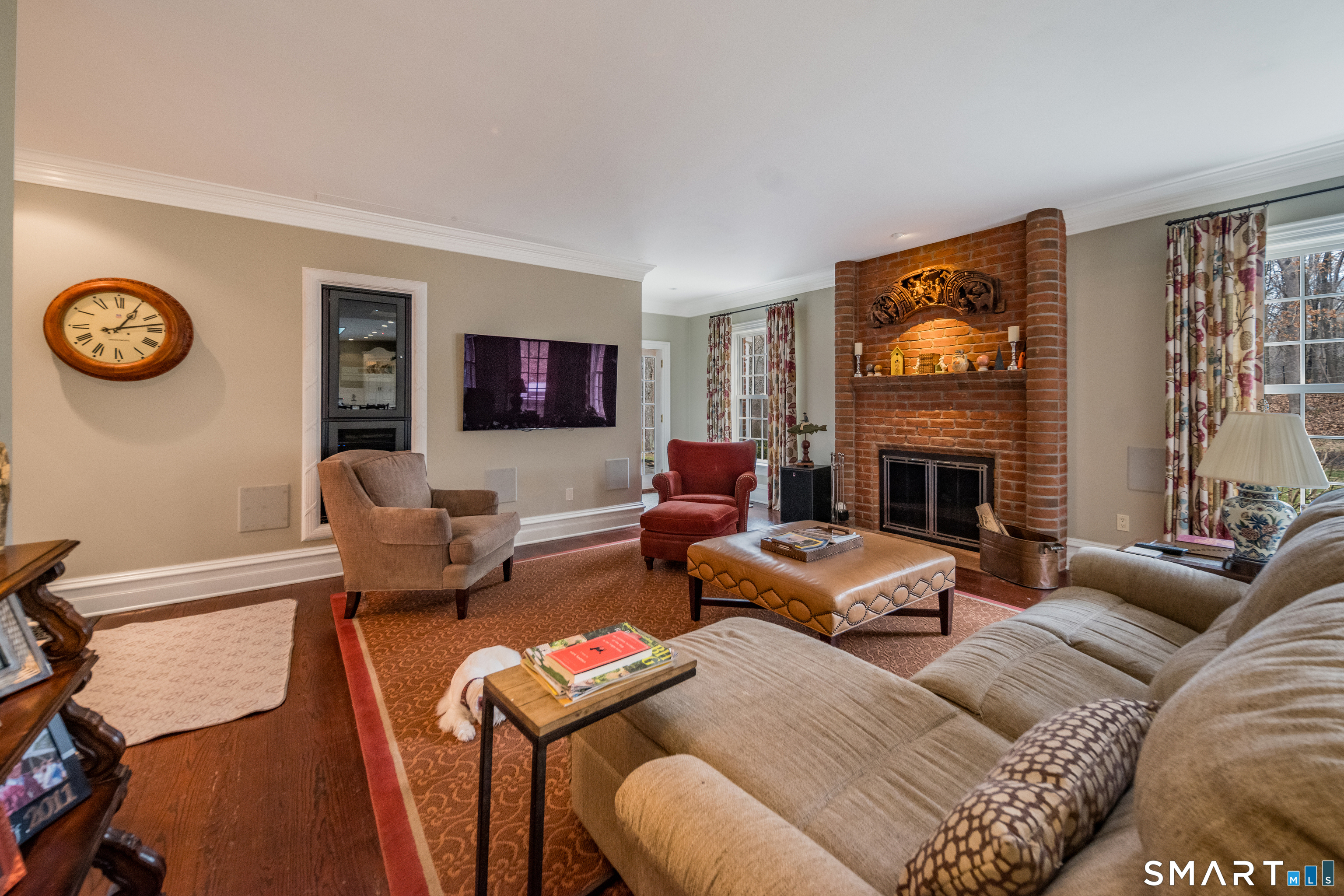 24 Indigo Trail Madison, CT 06443 - Photo 15 of 40 a living room with furniture a flat screen tv and a fireplace