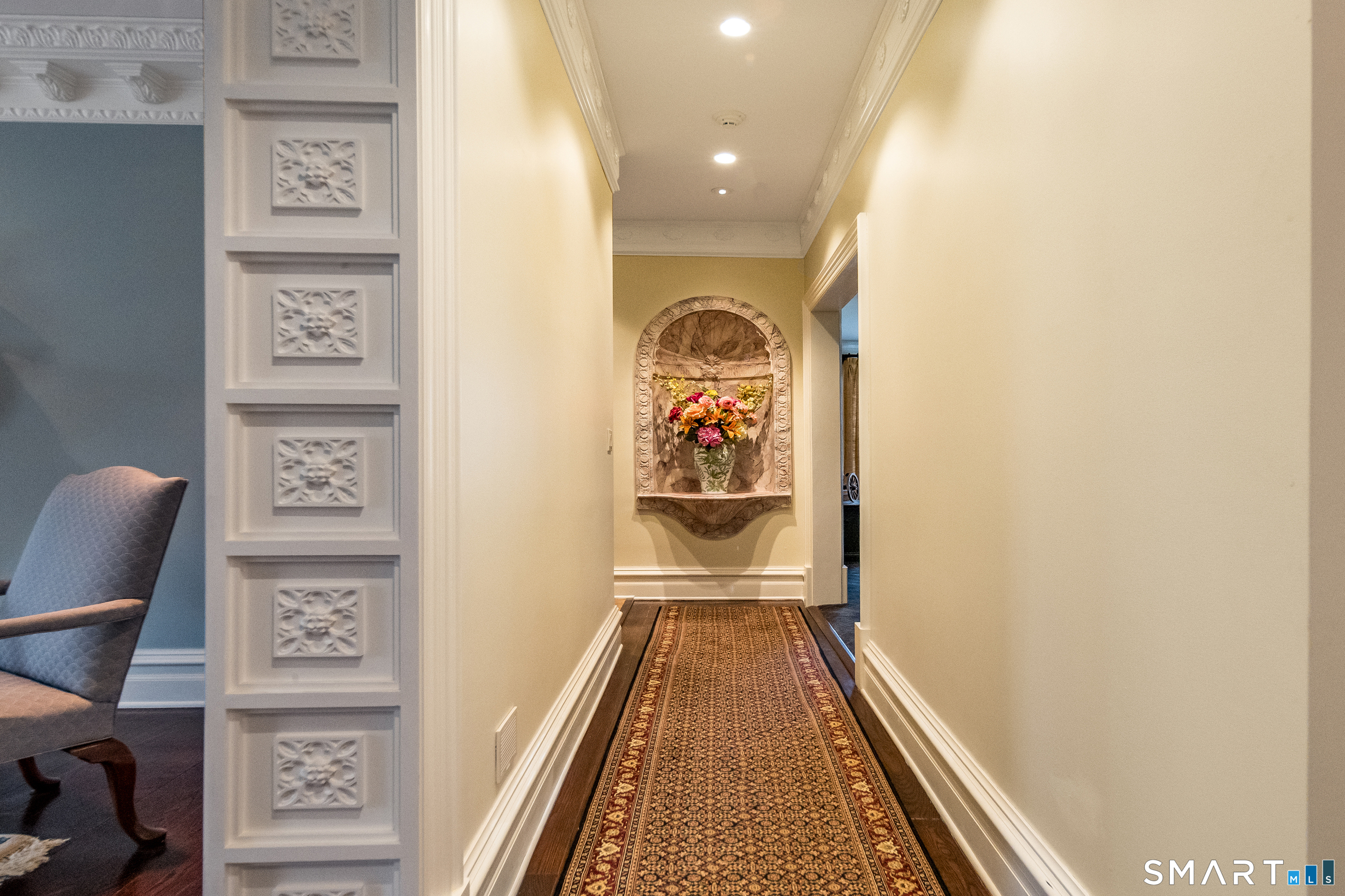 24 Indigo Trail Madison, CT 06443 - Photo 19 of 40 a view of a hallway with paintings on the wall