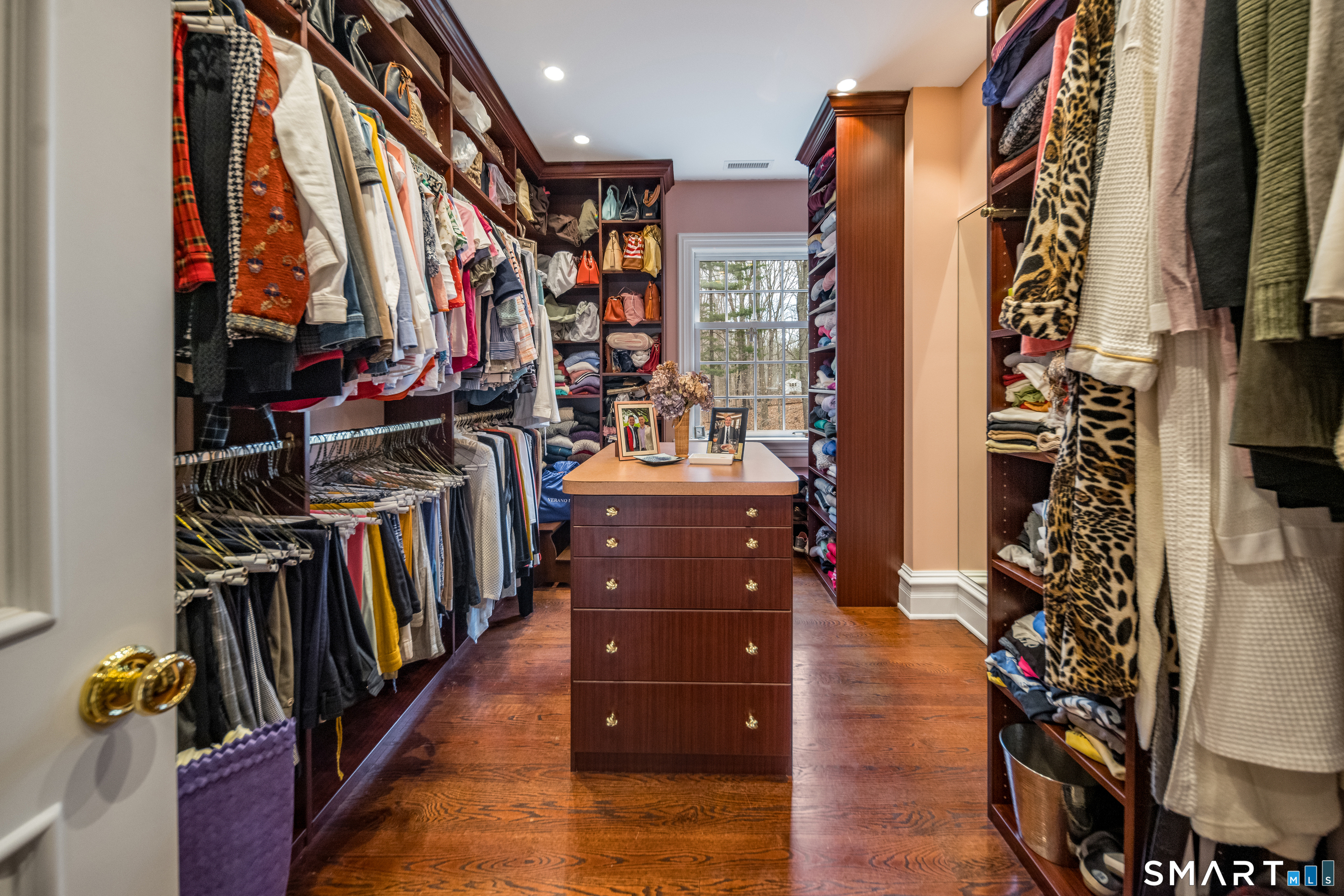 24 Indigo Trail Madison, CT 06443 - Photo 25 of 40 a view of walk in closet with clothes and shoes