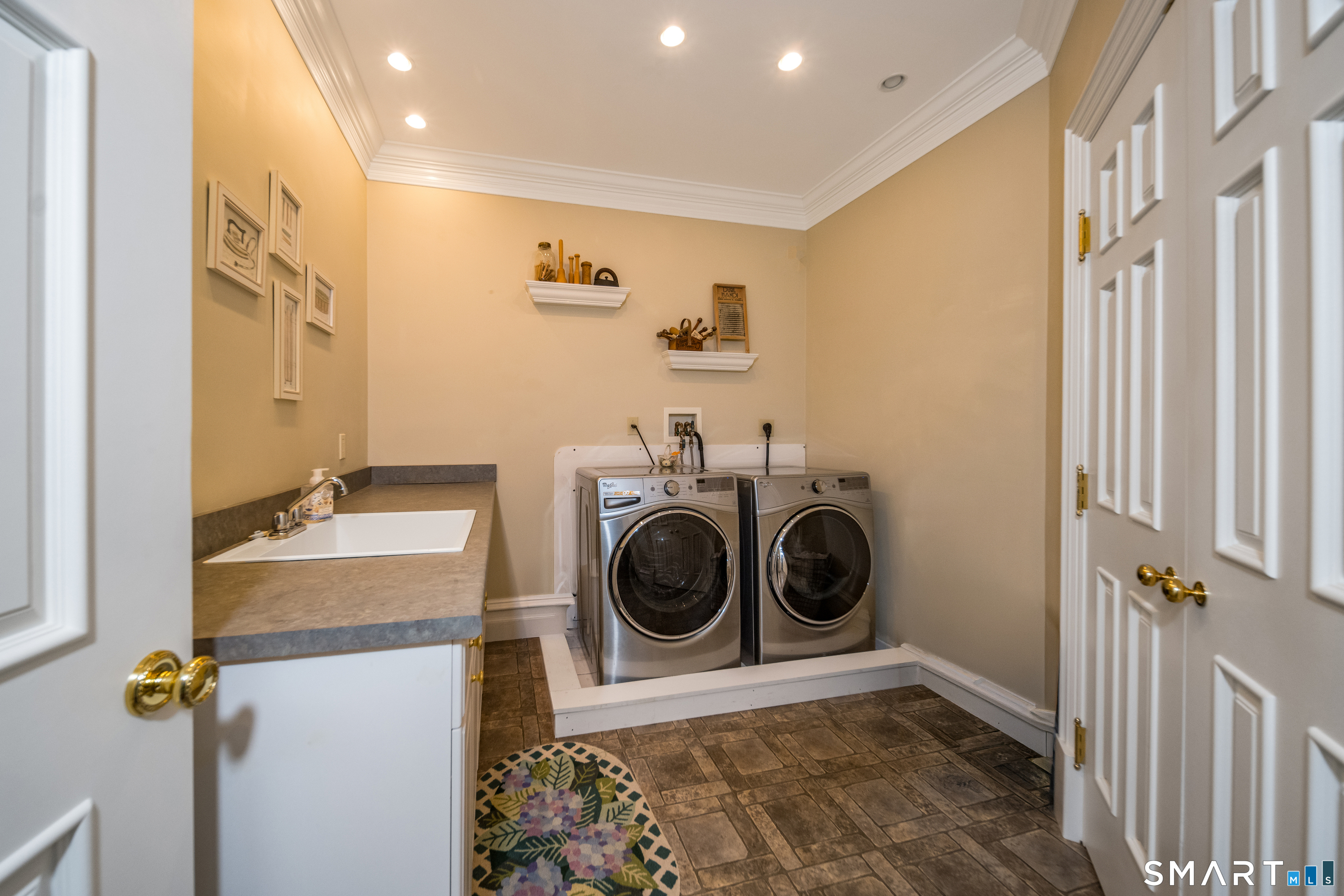 24 Indigo Trail Madison, CT 06443 - Photo 34 of 40 a view of a storage & utility room with a washer dryer