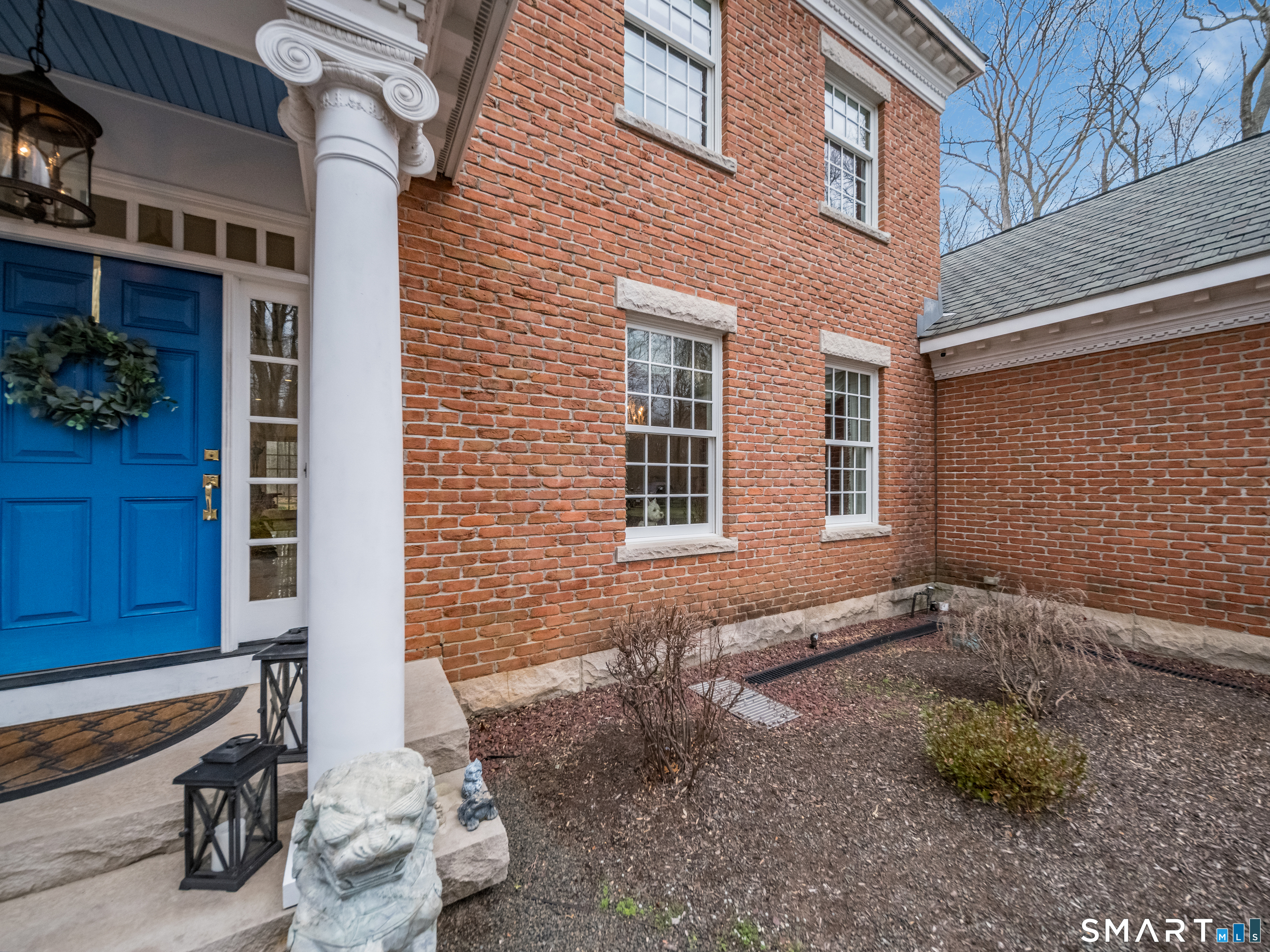 24 Indigo Trail Madison, CT 06443 - Photo 35 of 40 a view of an outdoor space with a car park in front of a brick building