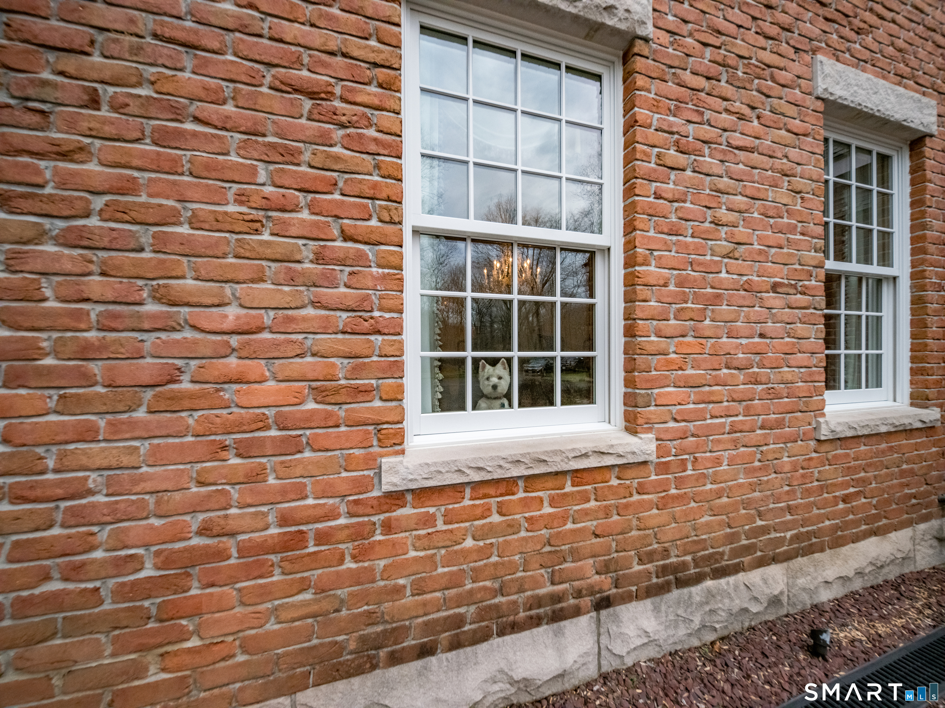 24 Indigo Trail Madison, CT 06443 - Photo 39 of 40 a front view of a brick house with a window