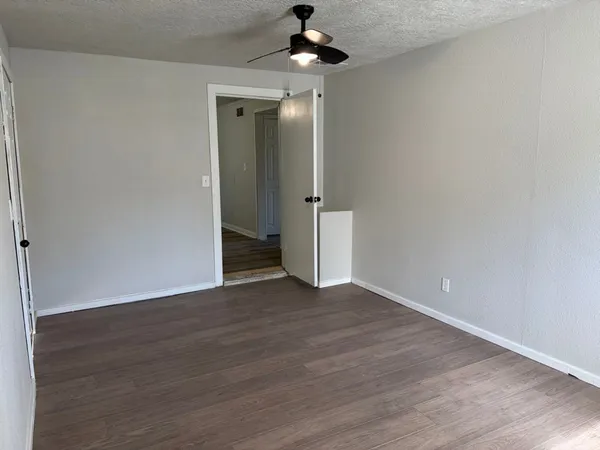 a view of an empty room and wooden floor