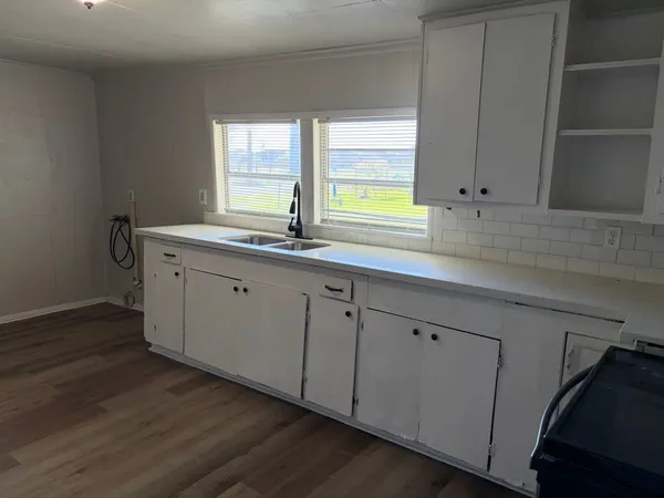 a kitchen with a sink cabinets and window
