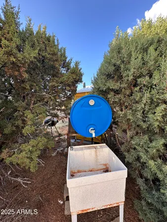 a backyard of a house with chairs and dryer