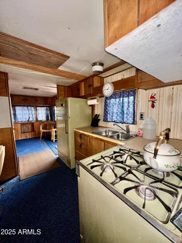 a kitchen with a refrigerator and a stove