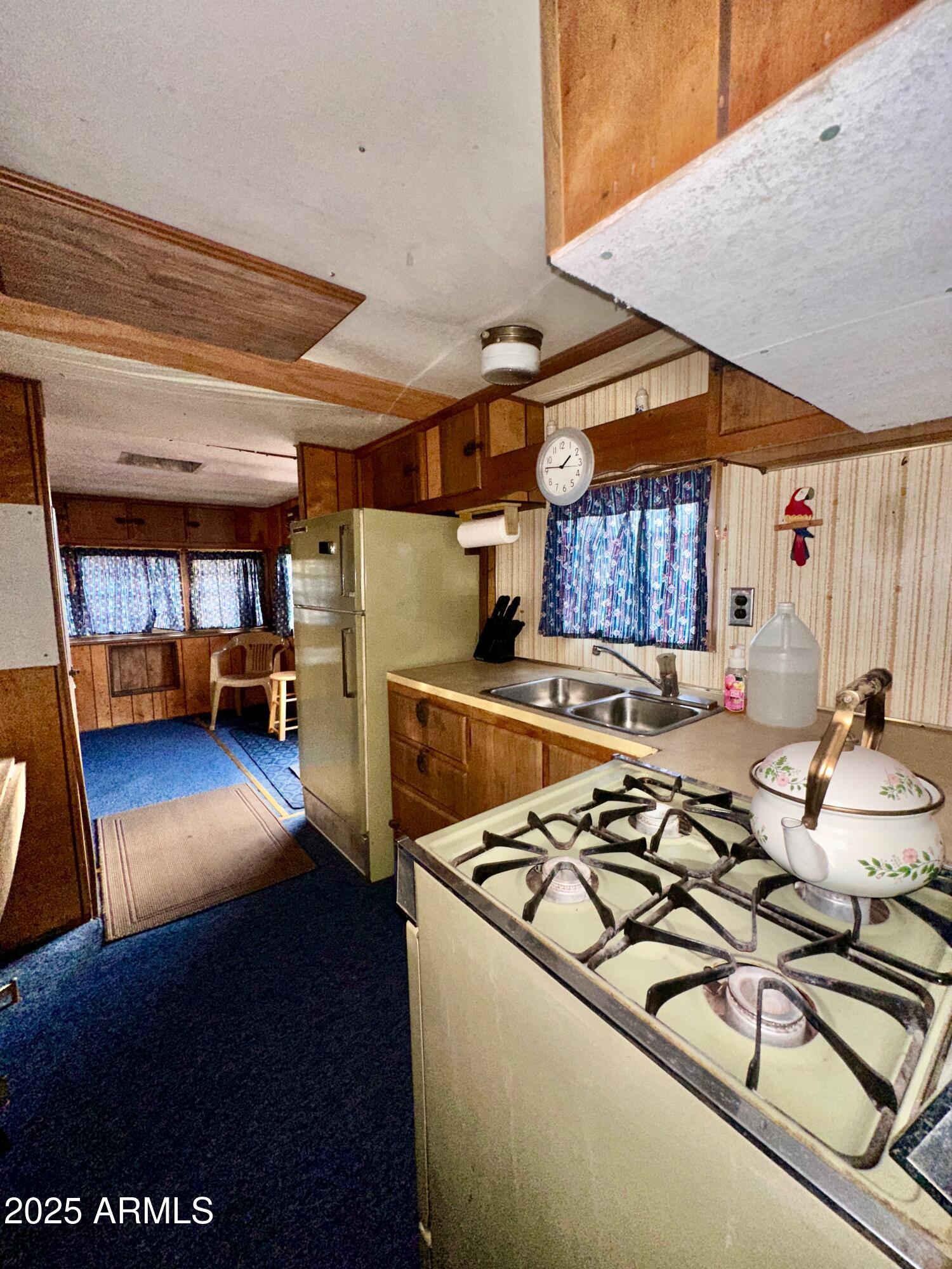 47 County Road, Unit 165 Show Low, AZ 85901 - Photo 16 of 30 a view of a kitchen with stainless steel appliances wooden floor and a refrigerator