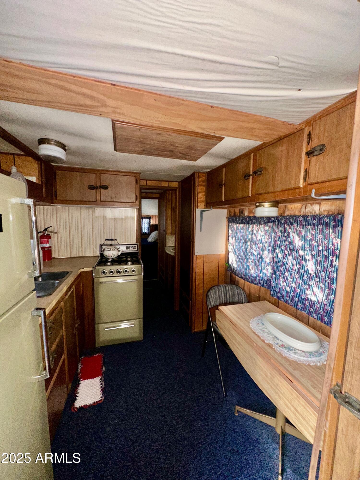 47 County Road, Unit 165 Show Low, AZ 85901 - Photo 17 of 30 a kitchen with a refrigerator and a stove