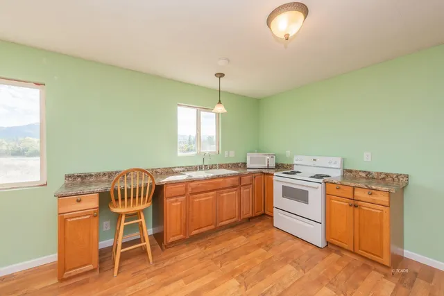 a kitchen with a stove a sink and a refrigerator