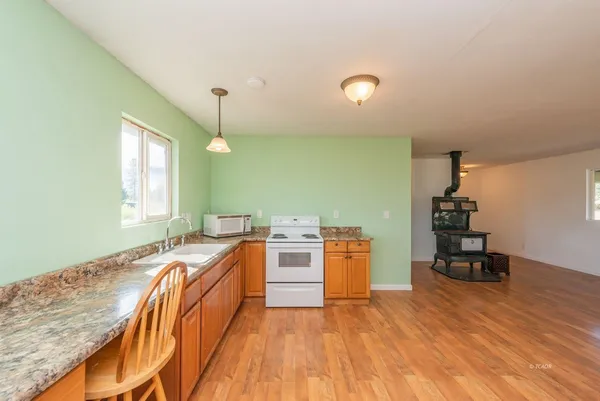 a kitchen with stainless steel appliances granite countertop a sink and stove top oven