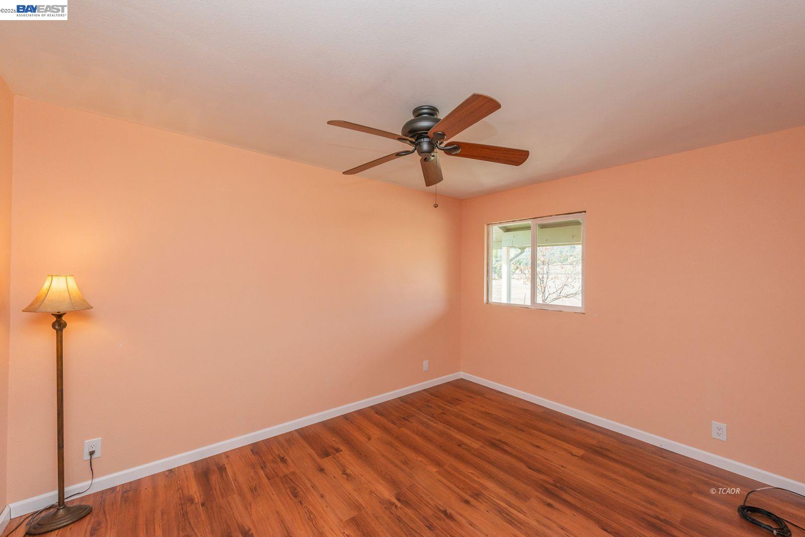 1095 Hyampom Road Hayfork, CA 96041 - Photo 20 of 41 a view of room with a ceiling fan and wooden floor