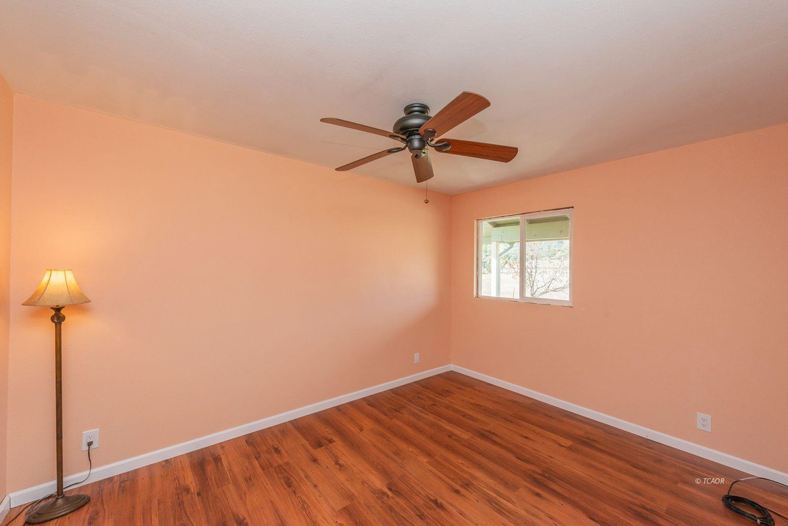 1095 Hyampom Road Hayfork, CA 96041 - Photo 20 of 41 a view of room with a ceiling fan and wooden floor