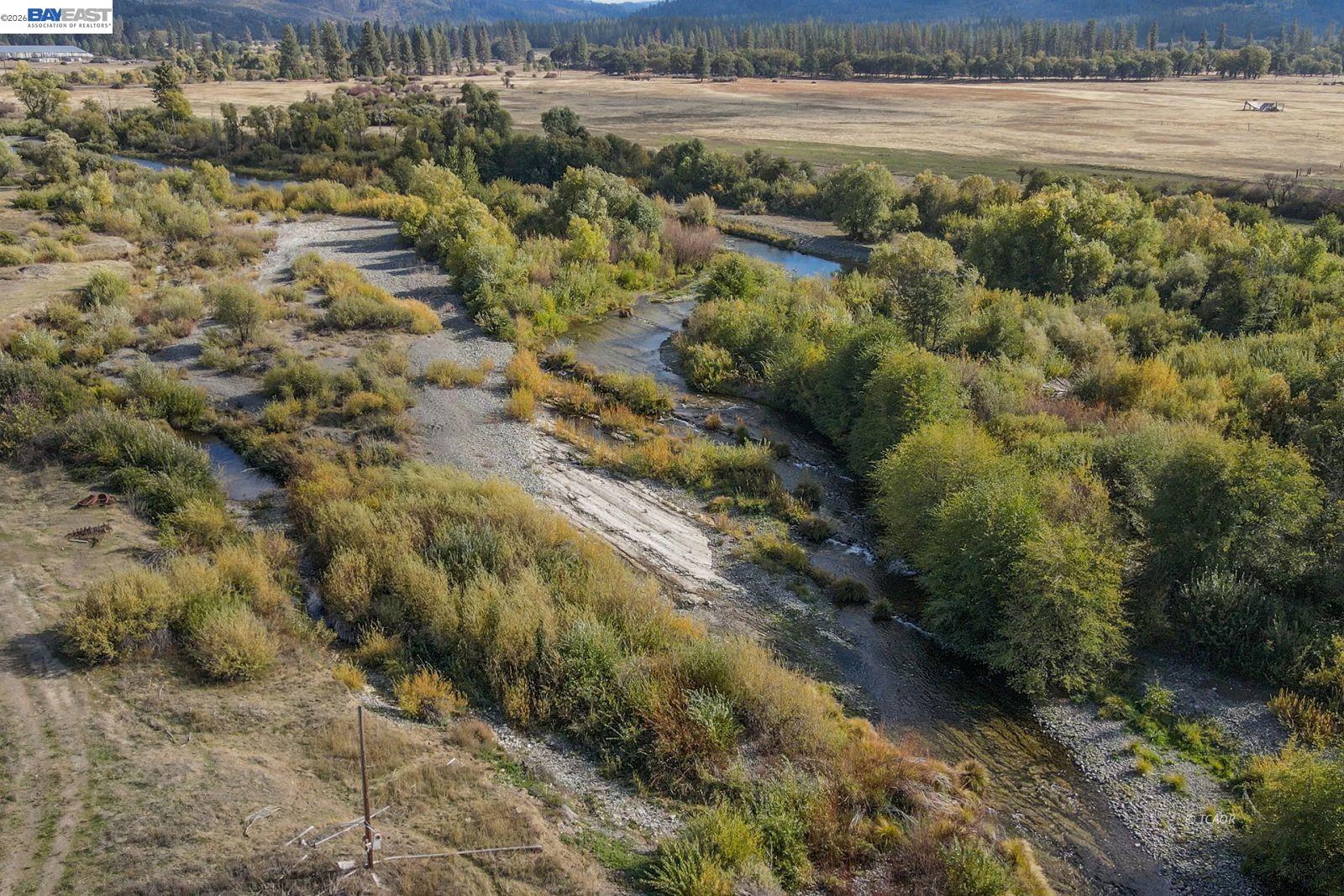 1095 Hyampom Road Hayfork, CA 96041 - Photo 30 of 41 a view of a lake with beach and green space