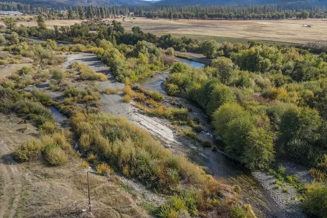 a view of a lake with beach and green space