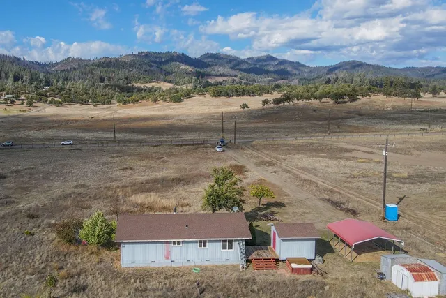 an aerial view of a house with a yard
