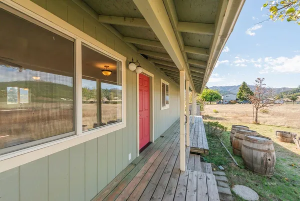 a view of a balcony with wooden floor and outdoor space