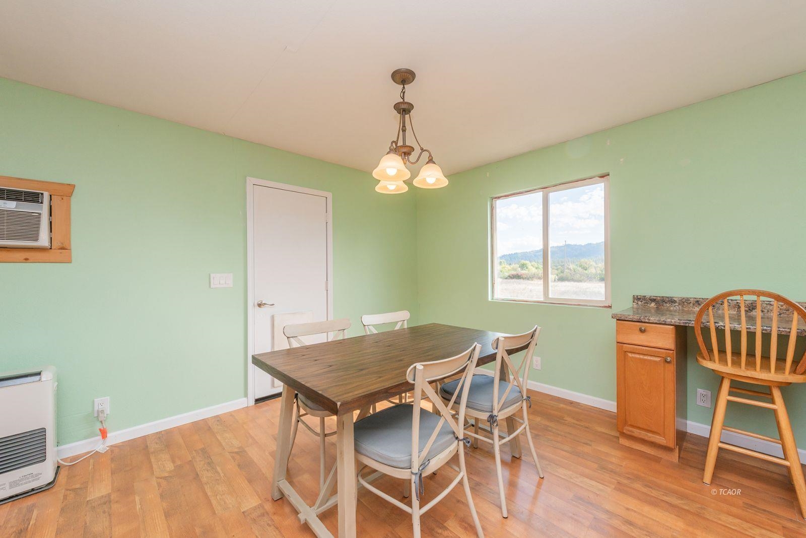 1095 Hyampom Road Hayfork, CA 96041 - Photo 10 of 41 a view of a dining room with furniture and wooden floor