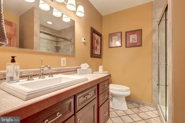 a spacious bedroom with a bed and wooden floor