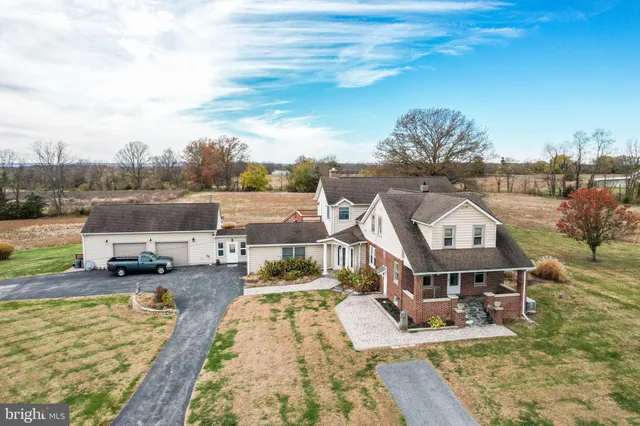 an aerial view of a house with garden space and street view