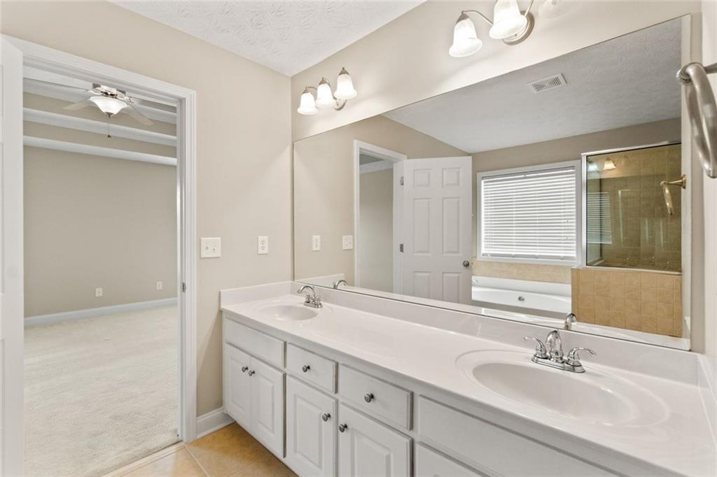 241 Red Bud Road Jefferson, GA 30549 - Photo 29 of 43 a bathroom with double vanity sink and a mirror