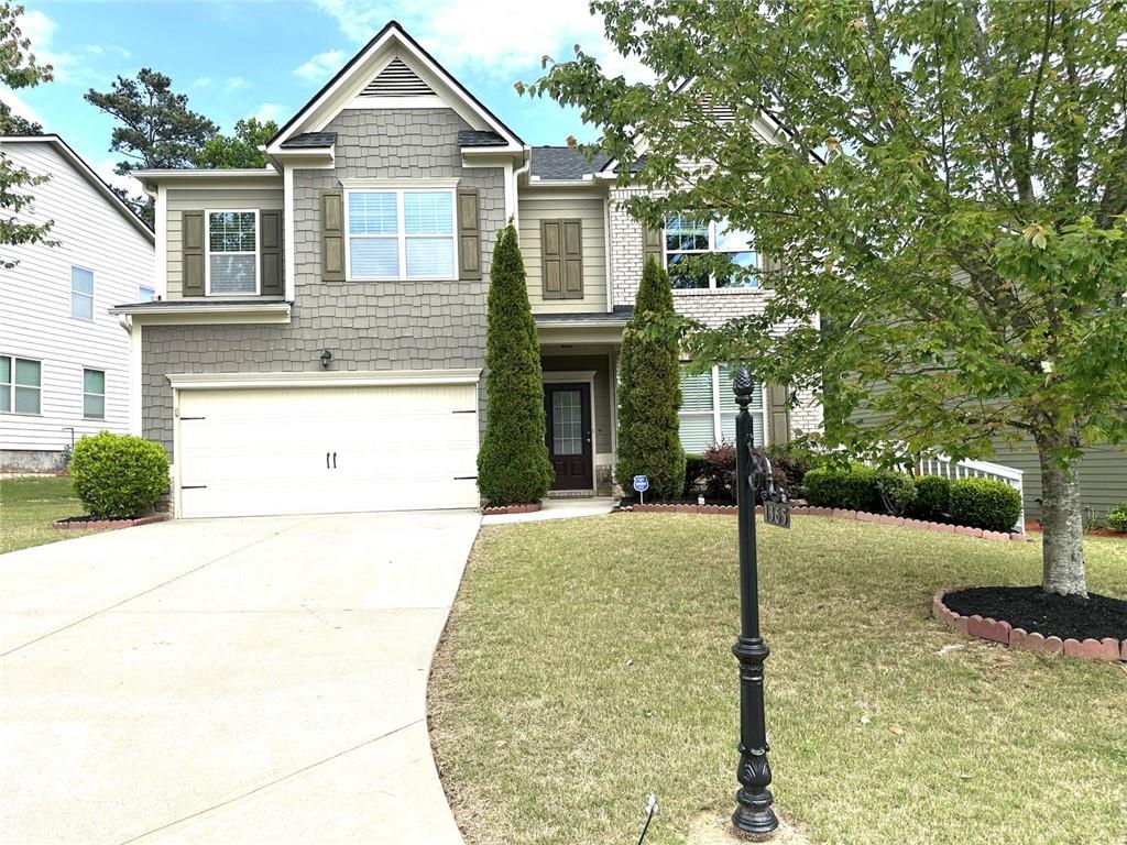 a front view of a house with a yard and garage
