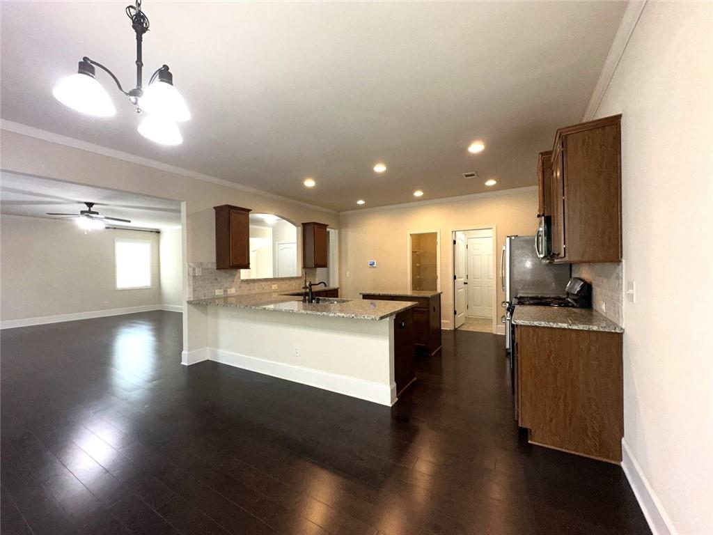1365 Delo Lane Cumming, GA 30041 - Photo 14 of 43 a large kitchen with stainless steel appliances a large counter top