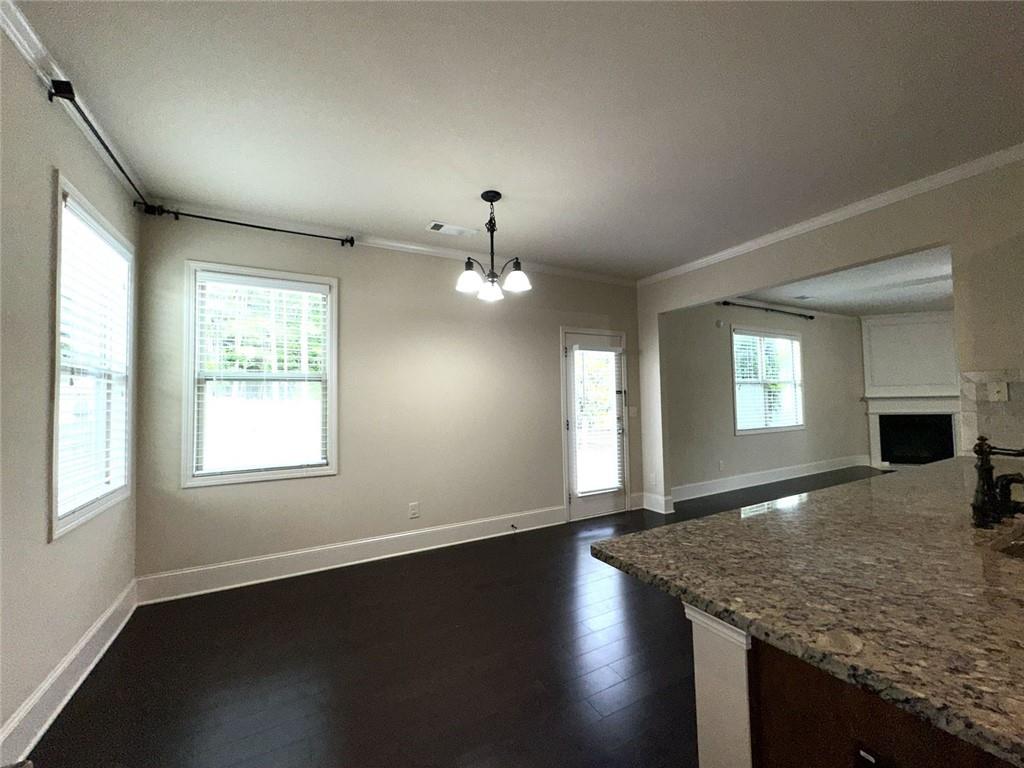 1365 Delo Lane Cumming, GA 30041 - Photo 15 of 43 an empty room with wooden floor and windows