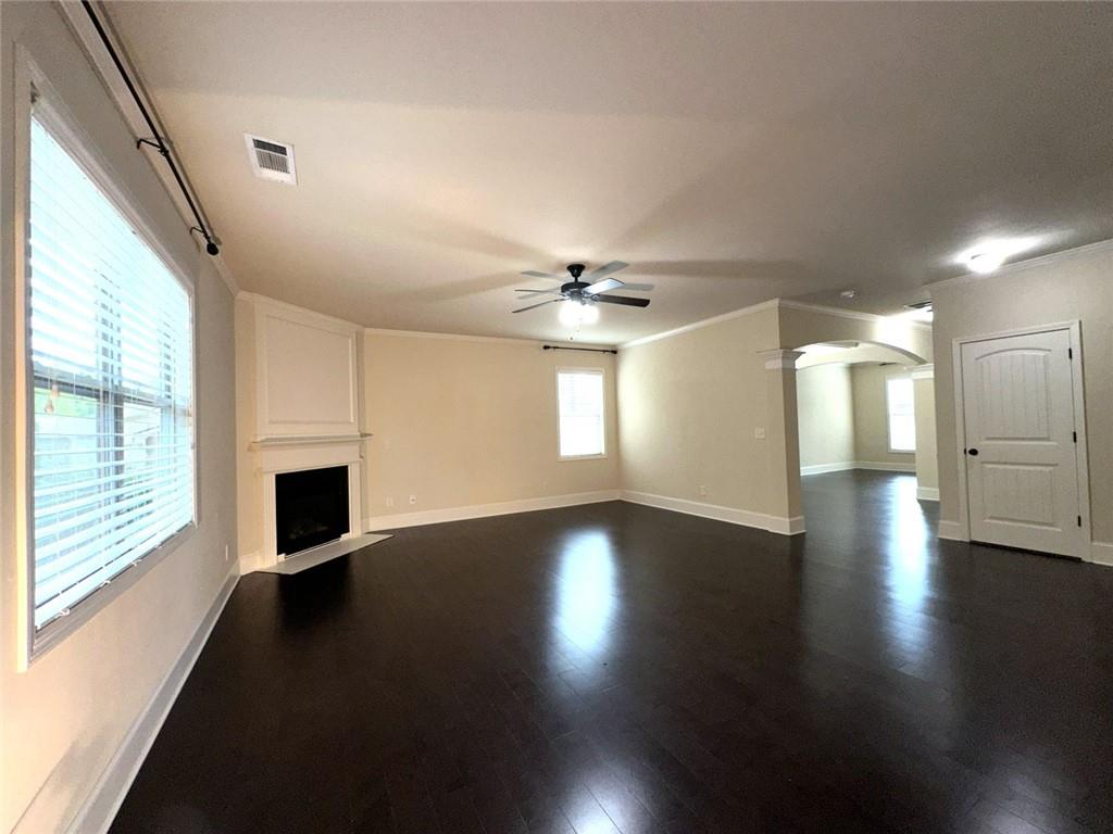 1365 Delo Lane Cumming, GA 30041 - Photo 16 of 43 a view of an empty room with wooden floor and a window