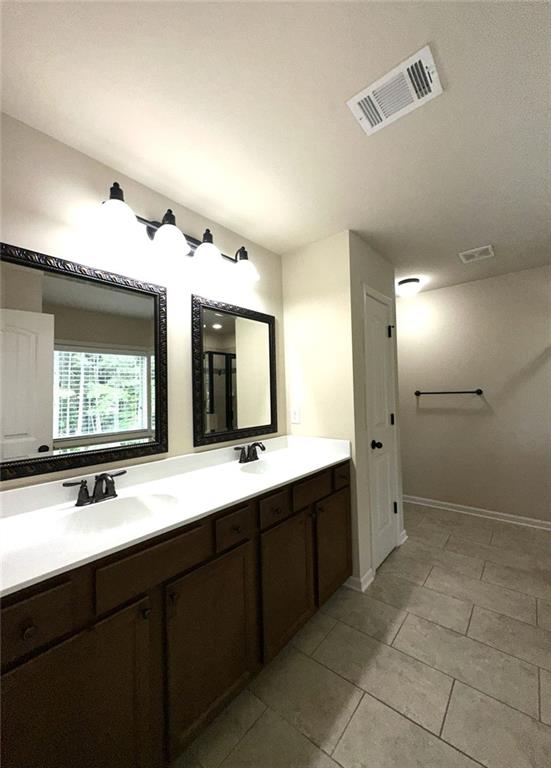 1365 Delo Lane Cumming, GA 30041 - Photo 25 of 43 a bathroom with a double vanity sink mirror and