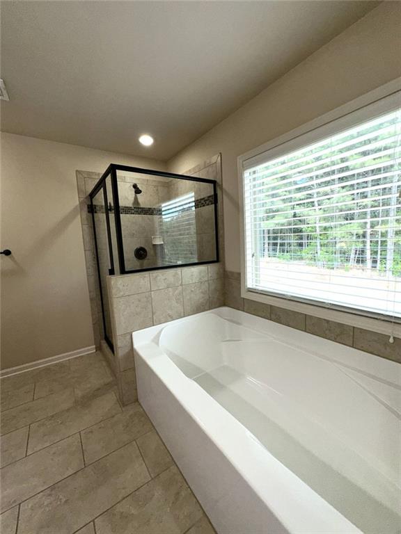 1365 Delo Lane Cumming, GA 30041 - Photo 26 of 43 a bathroom with a bathtub and a shower