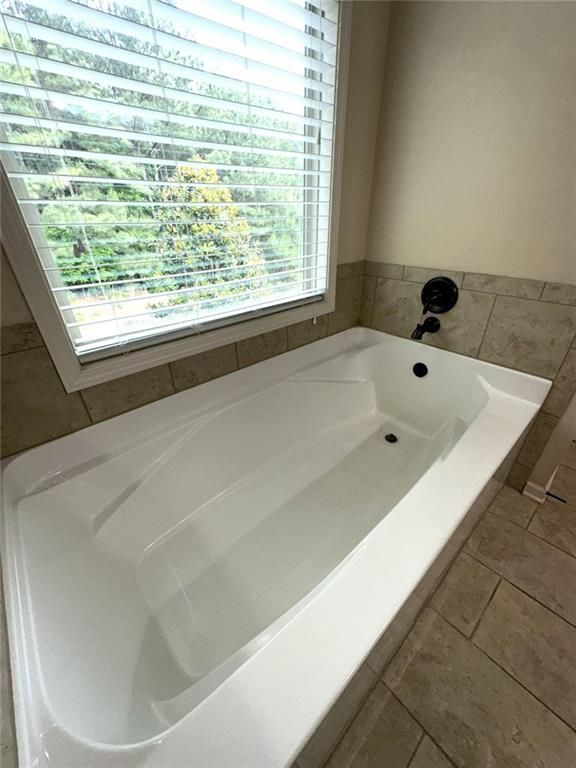 1365 Delo Lane Cumming, GA 30041 - Photo 27 of 43 a bathroom with a bathtub