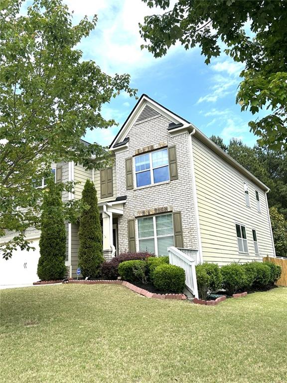 1365 Delo Lane Cumming, GA 30041 - Photo 3 of 43 a front view of a house with yard and green space