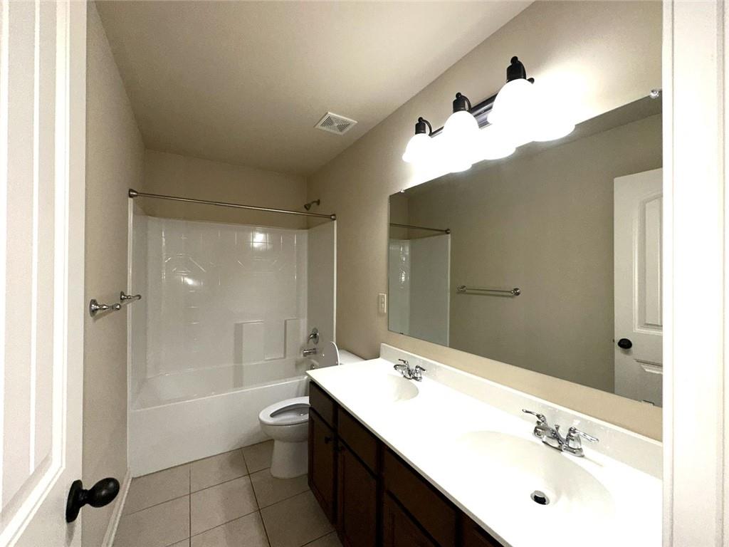 1365 Delo Lane Cumming, GA 30041 - Photo 32 of 43 a bathroom with a bathtub shower sink and a mirror
