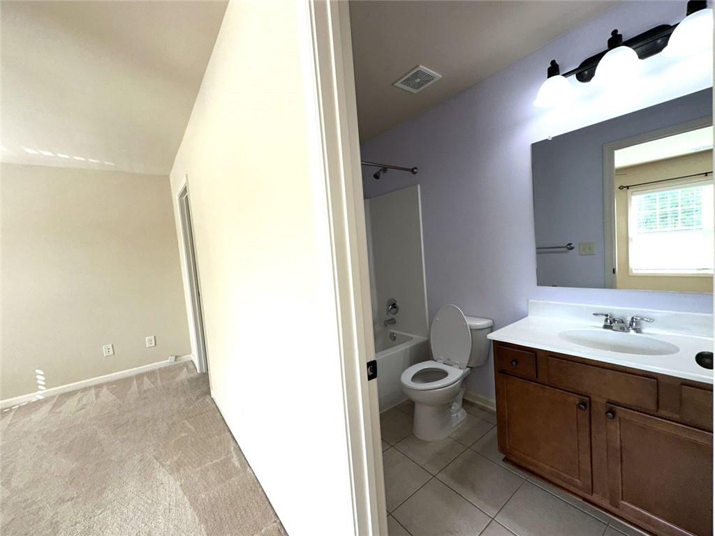 1365 Delo Lane Cumming, GA 30041 - Photo 36 of 43 a bathroom with a sink and a mirror